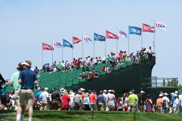 as the crowd watches along the 18th.