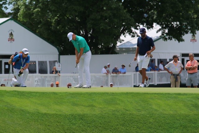 Jordan gets to work on the greens.