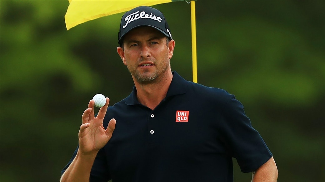 Adam Scott salutes the crowd with his Pro V1 glf ball after holing a birdie putt at the 2019 PGA Championship