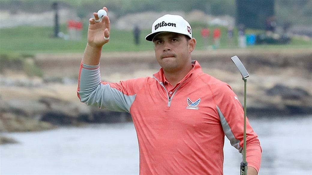 Gary Woodland raises his Pro V1 golf ball to salute the crowd after winning the 119th U.S Open at Pebble Beach