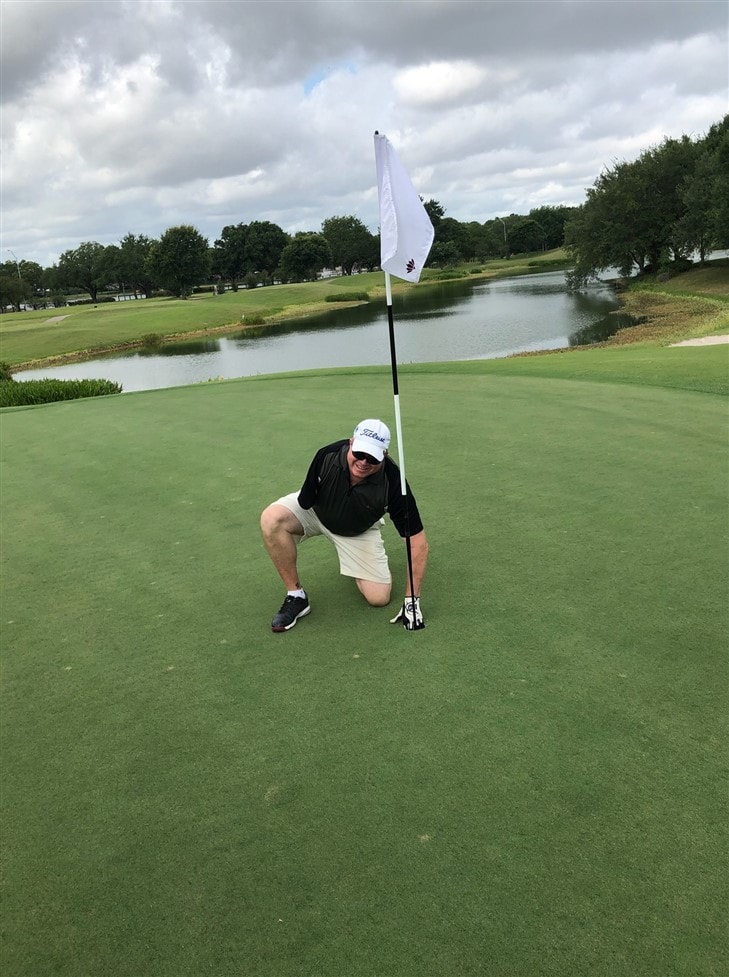 One armed golfer, shoots and scores a,hole in one
